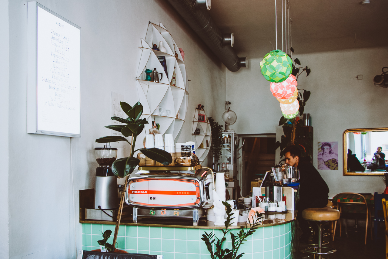 Faema E61 coffee machine on top of a retro green tiled countertop inside Kohvik August. Tallinn, Estonia